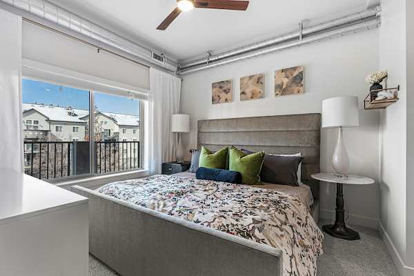 A bedroom with a large bed and large window at The Revival, Salt Lake City, 84101